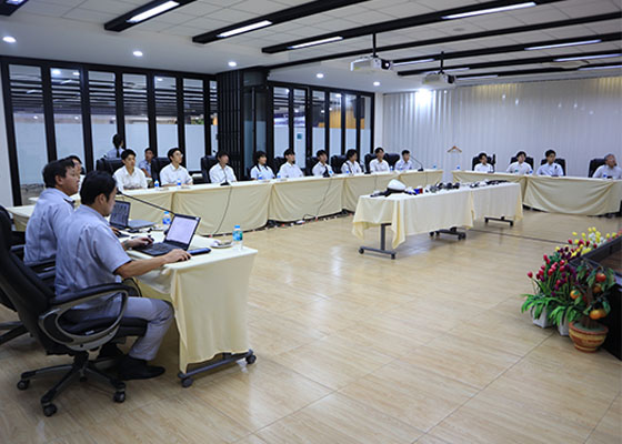 Participants listening to a business overview presentation indoors.
