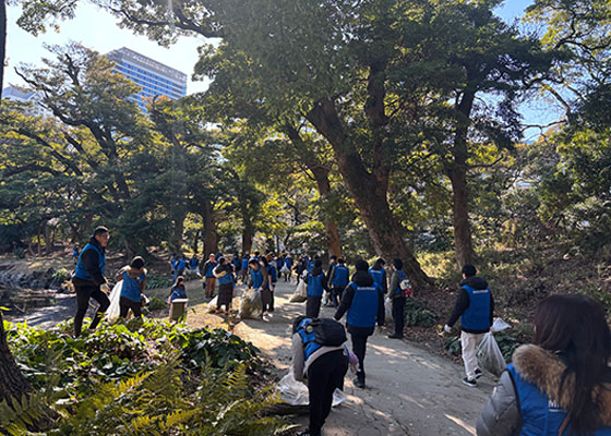 Employees and their families participating in a cleanup activity.