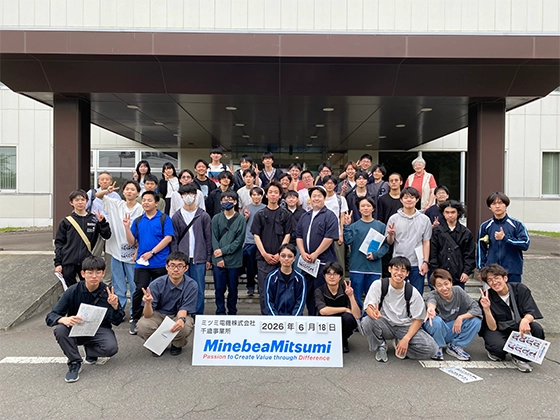 Group photo of students on a factory tour.